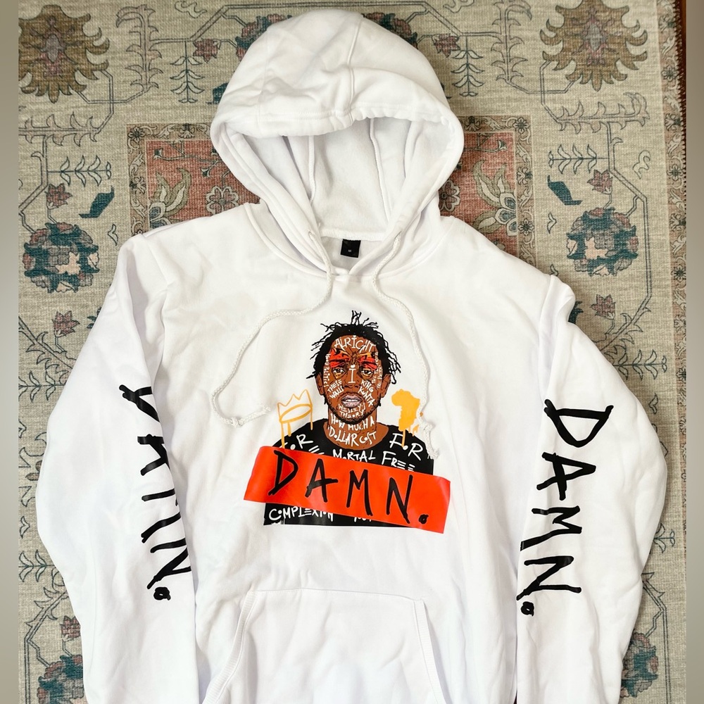 White Kendrick Lamar hoodie, graphics on front and sleeves. Size medium.